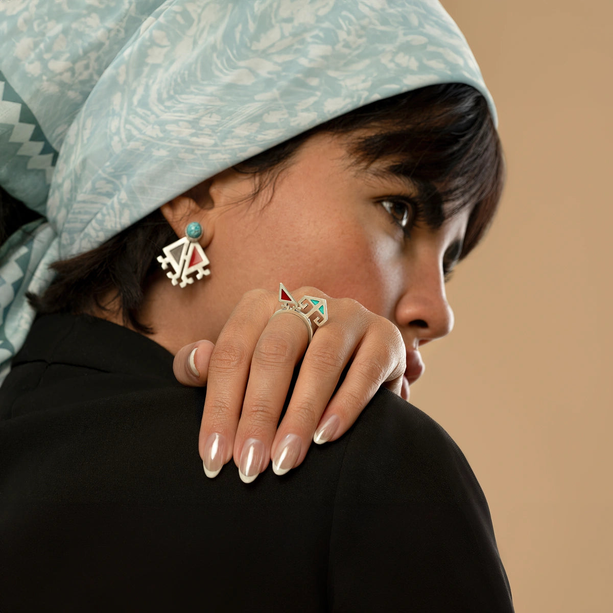 model wearing handmade minimalist matching silver rings with blue and red enamel