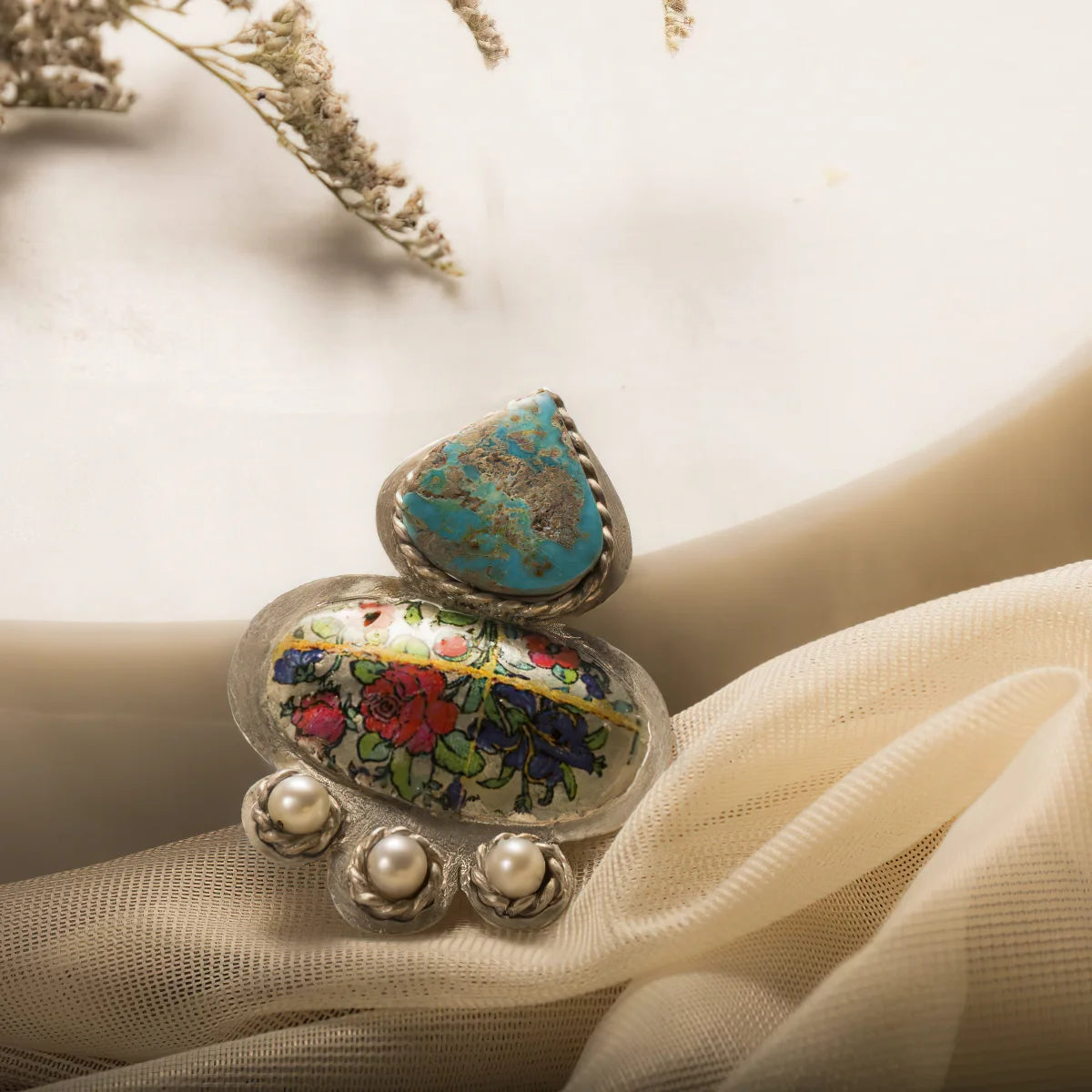 handmade silver brooch with floral patterns, pearls and turquoise