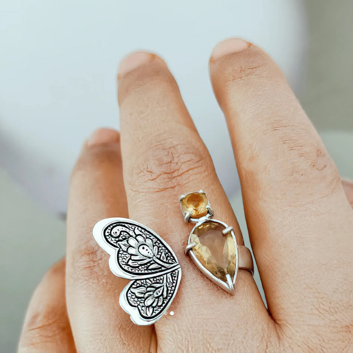 hand-engraved silver butterfly statement ring with floral patterns and citrine gemstones