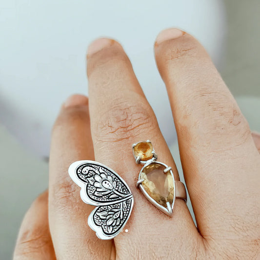 hand-engraved silver butterfly statement ring with floral patterns and citrine gemstones