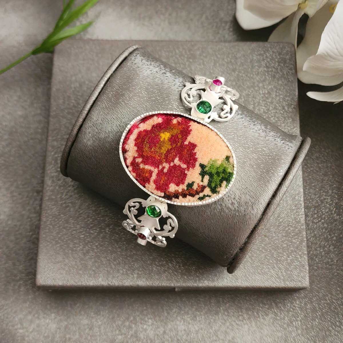 handmade intricate openwork silver statement bracelet with oval Persian style rug and green and pink crystals