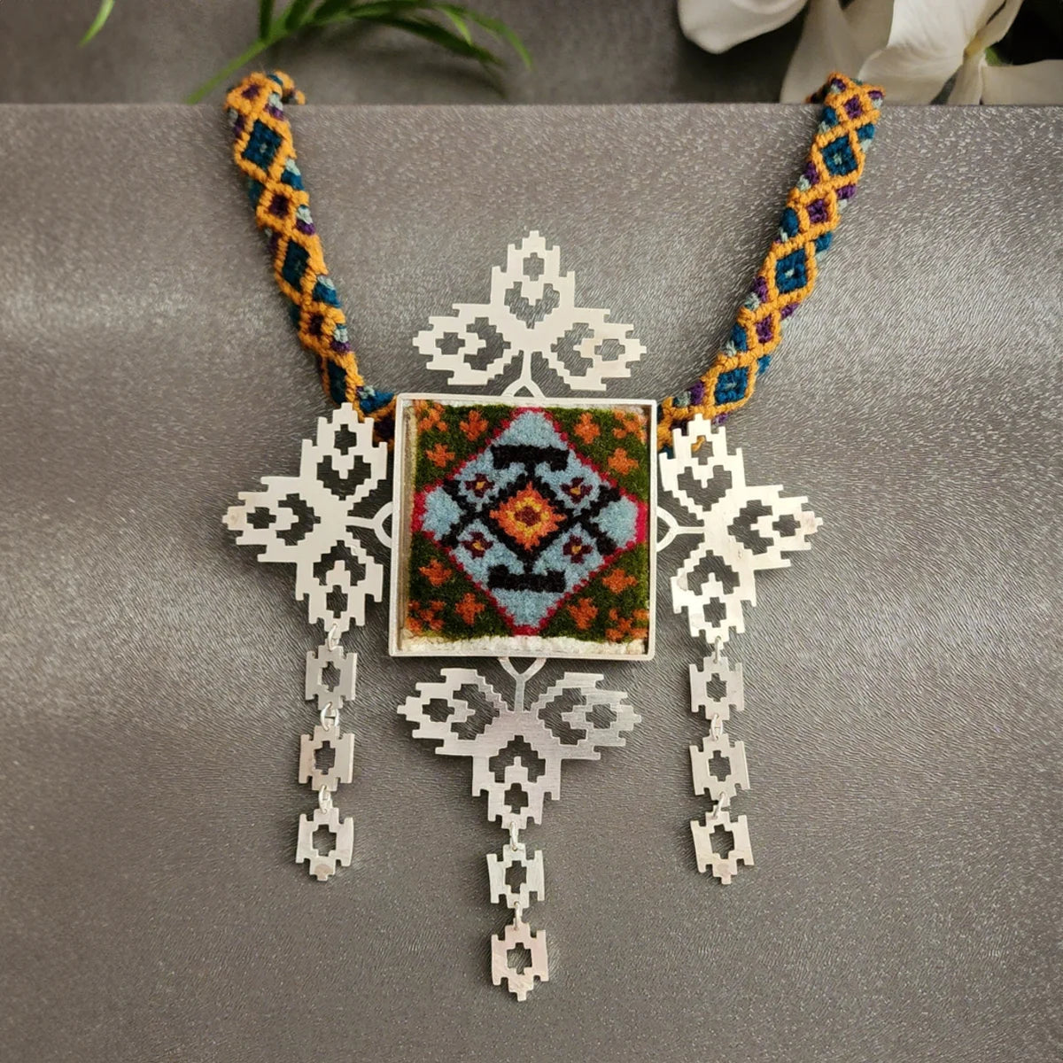 handmade openwork silver statement necklace with green, orange and blue colored Persian rug decoration