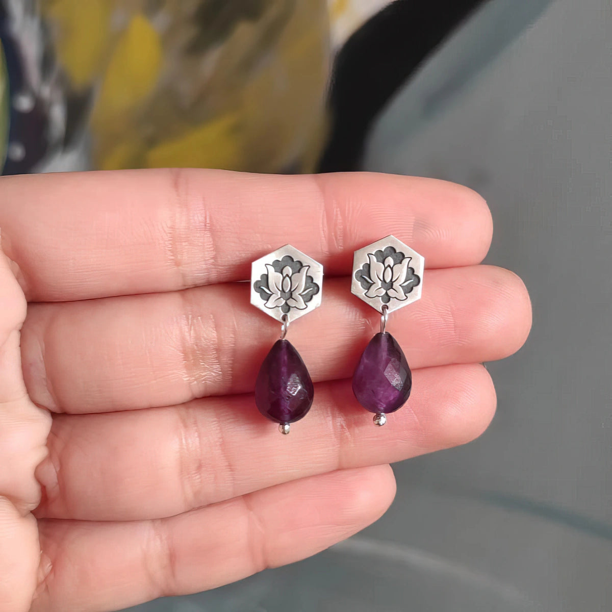 handmade oxidized silver dangle earrings with amethyst demonstration on hand