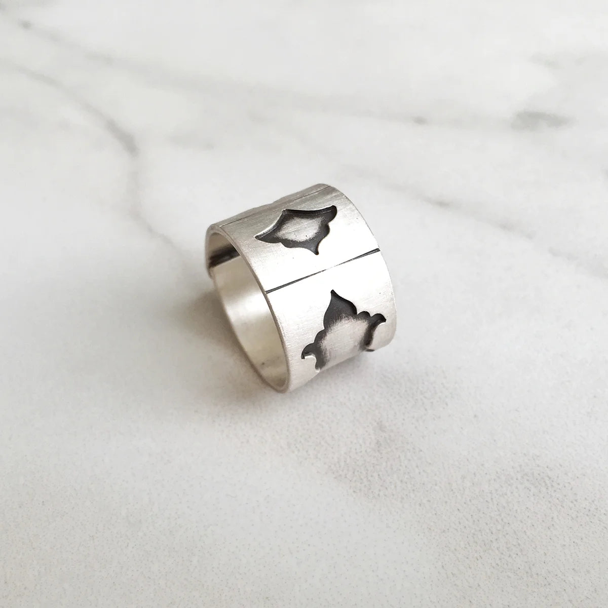 handmade oxidized silver statement ring with musical instrument shapes indented