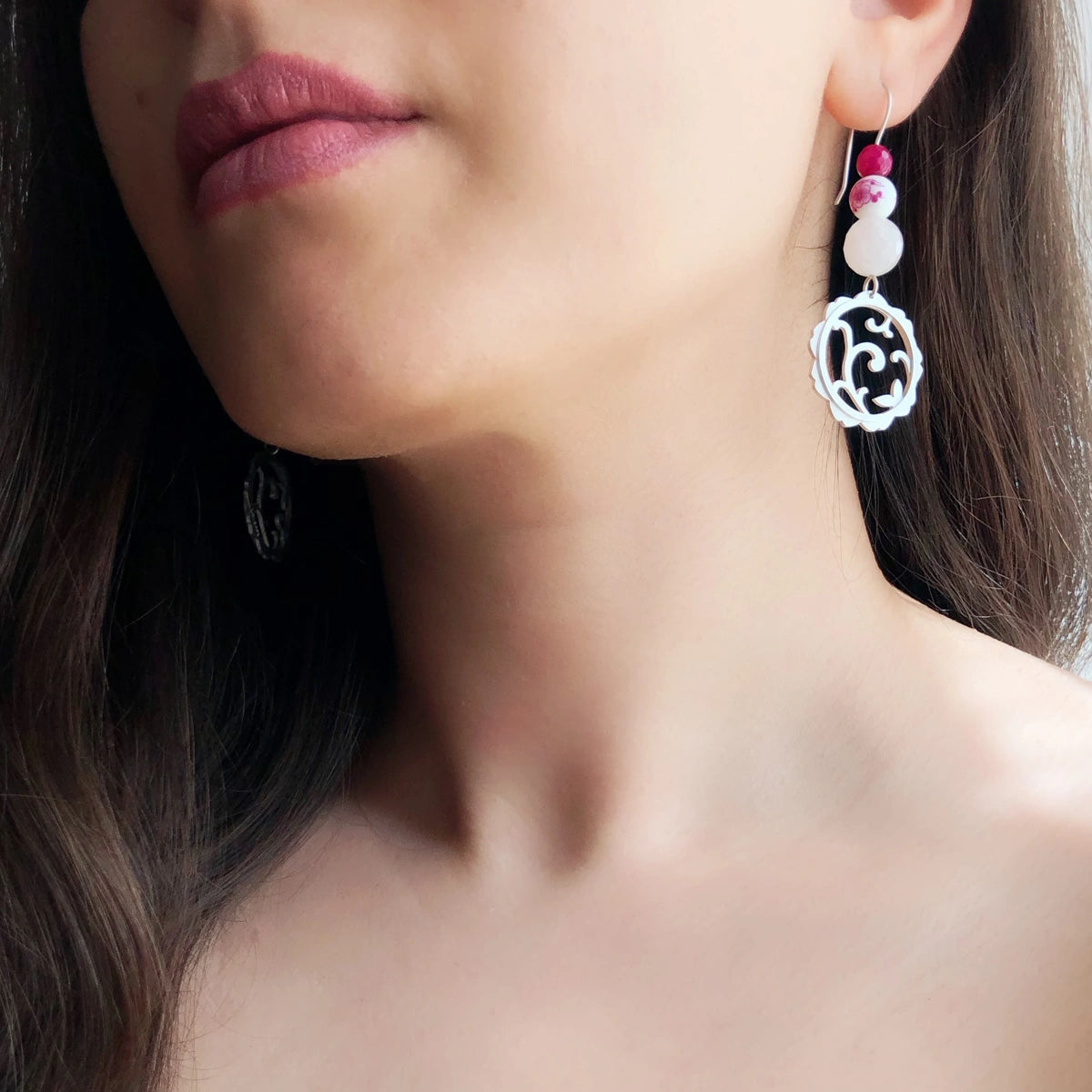 model wearing floral openwork silver dangle earrings with rose quartz and agate