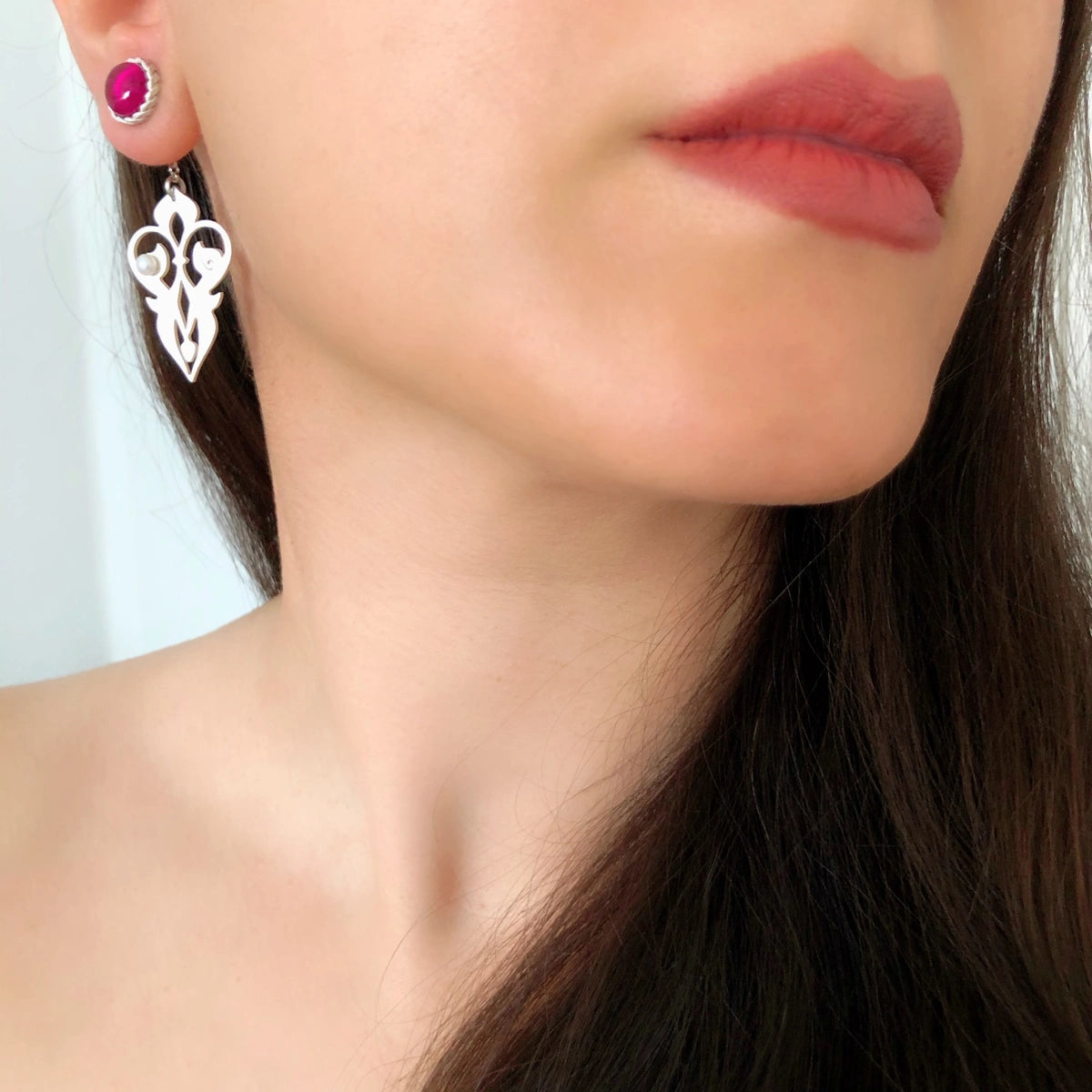 model wearing handmade silver two way earrings with ruby and pearls
