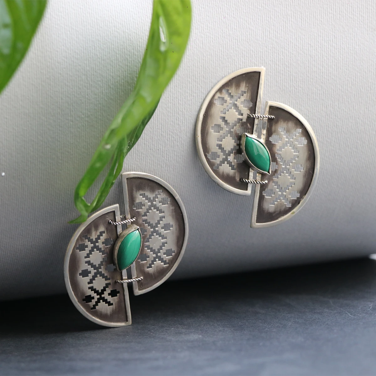 handmade openwork oxidized silver statement earrings in the shape of 2 half-circles with malachite