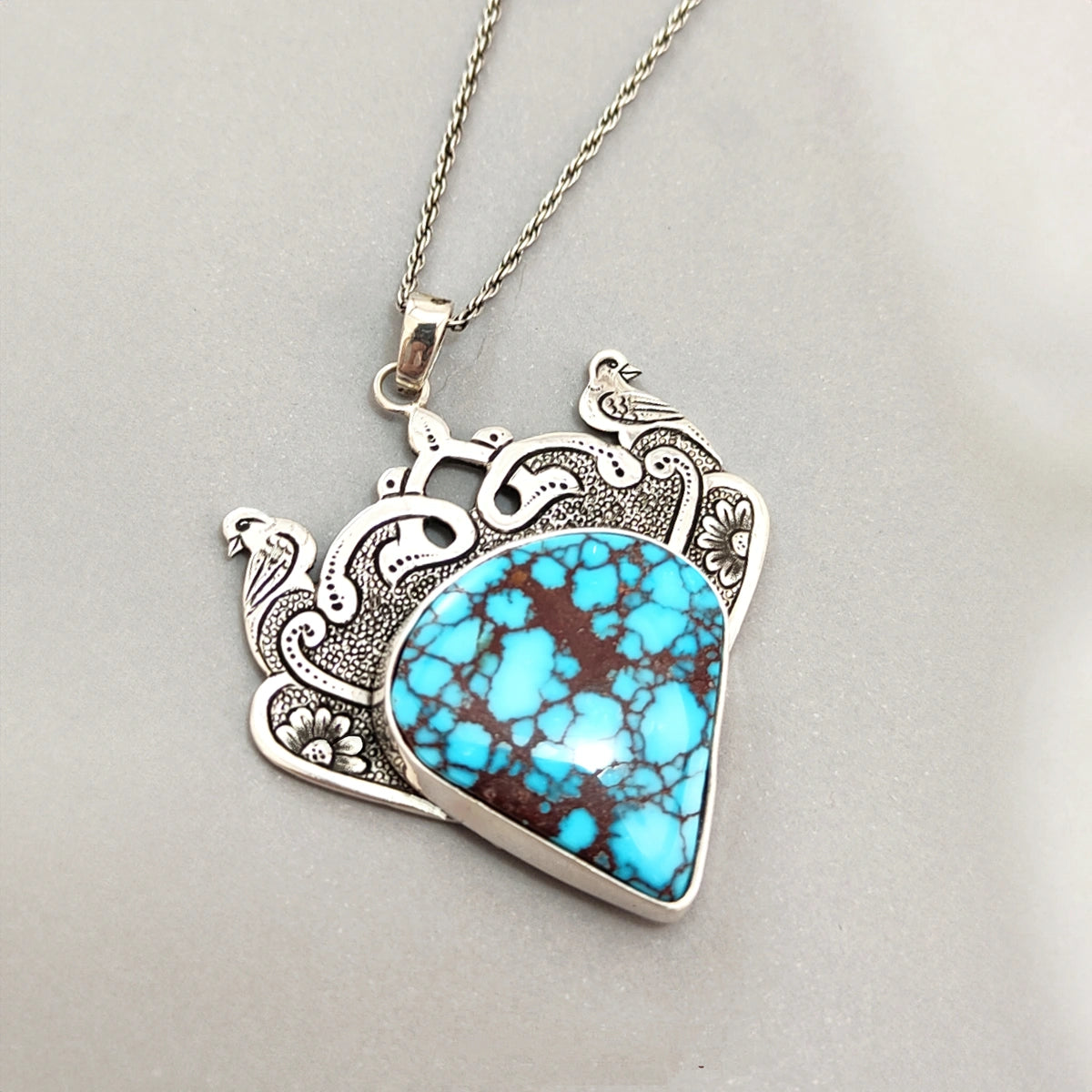 hand-engraved handmade birds and floral motif silver pendant with turquoise