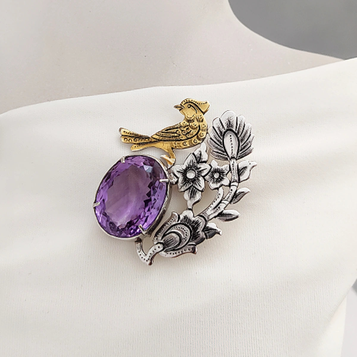 hand-engraved silver brooch with flowers and gold plated bird decorated with amethyst