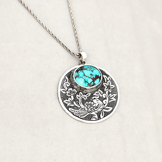 hand-engraved silver medallion necklace with floral motifs and Persian turquoise