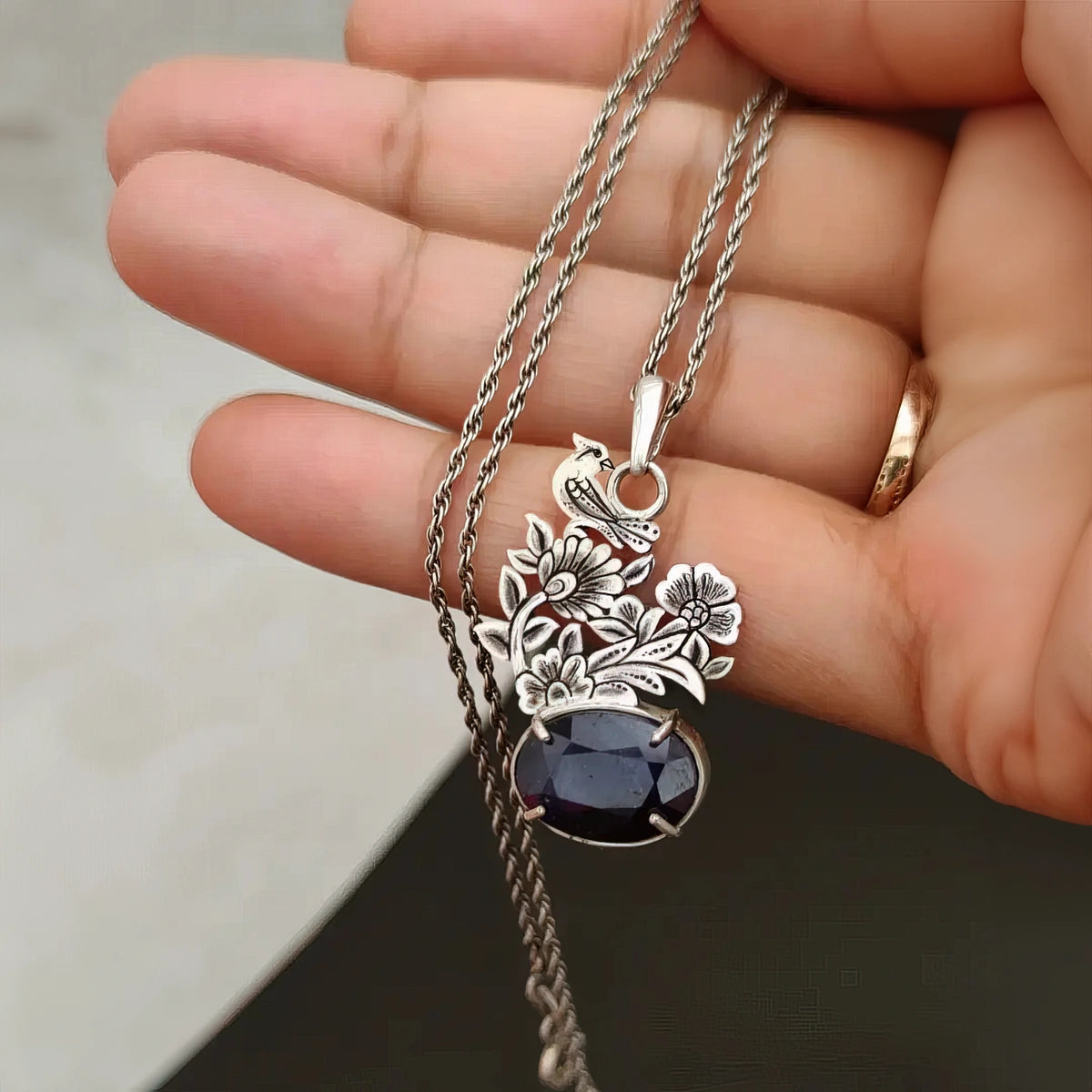 hand-engraved handmade bird and flowers silver necklace with blue sapphire