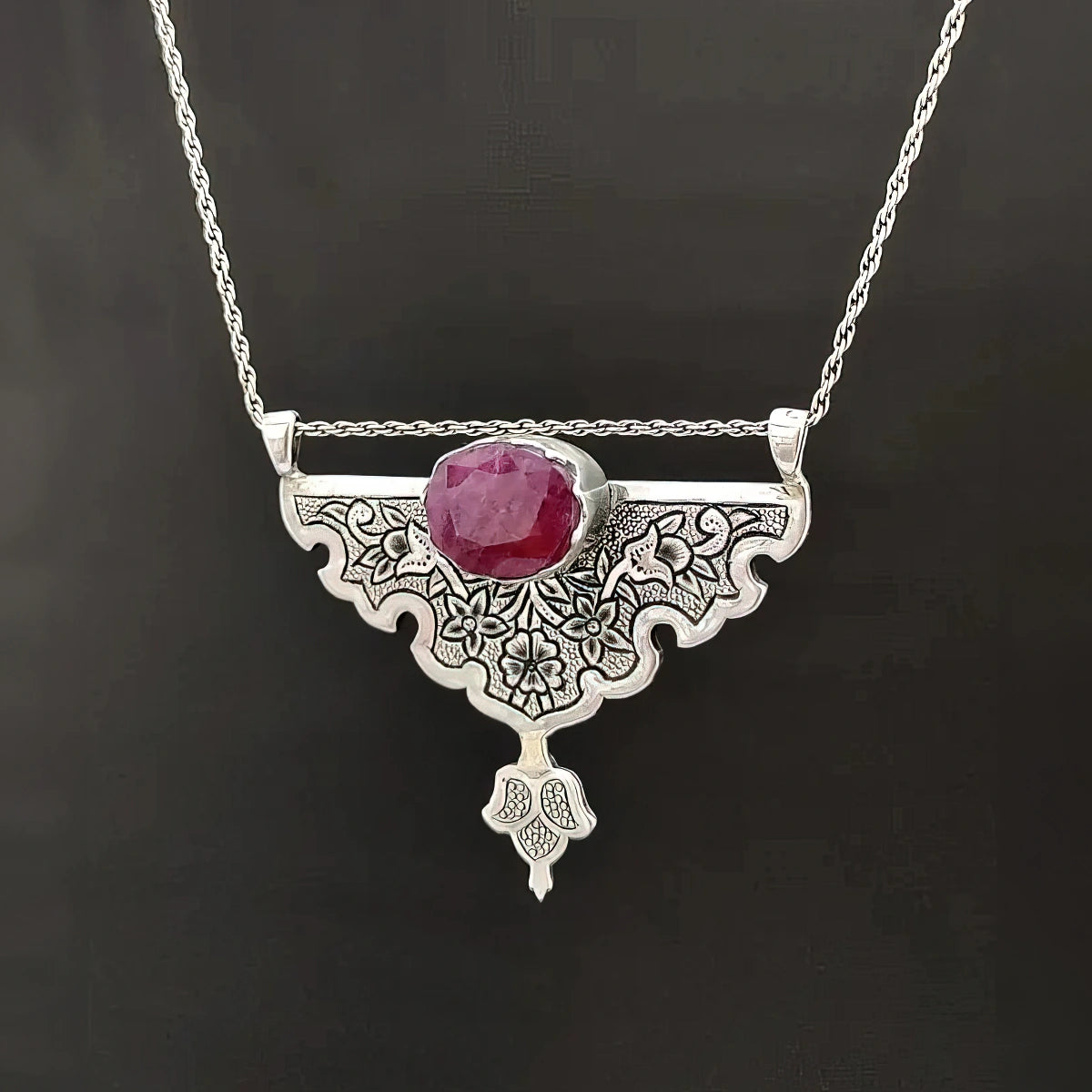 hand-engraved handmade floral silver pendant with oval ruby