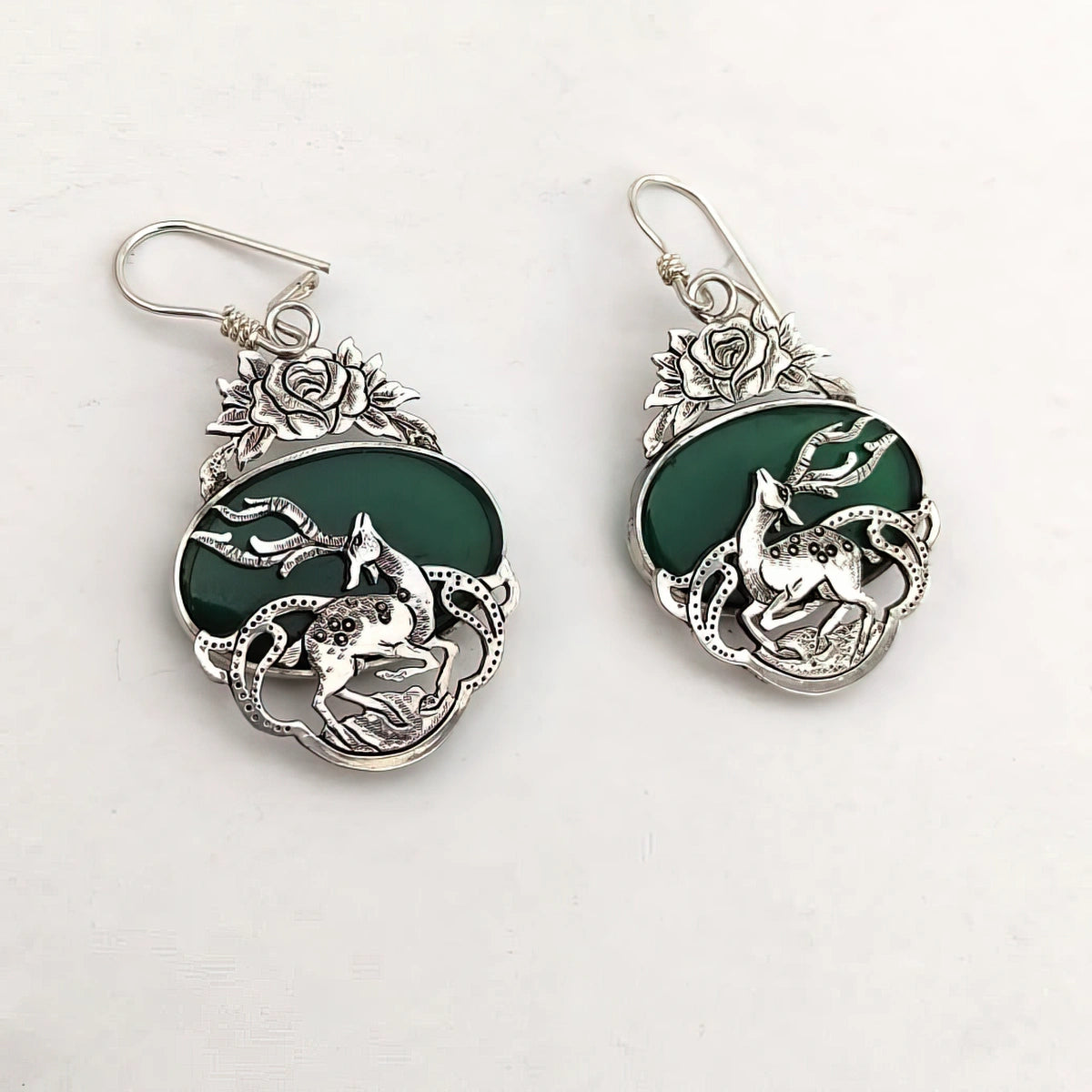 hand-engraved silver gazelle statement earrings with flower motifs and green agate gemstones