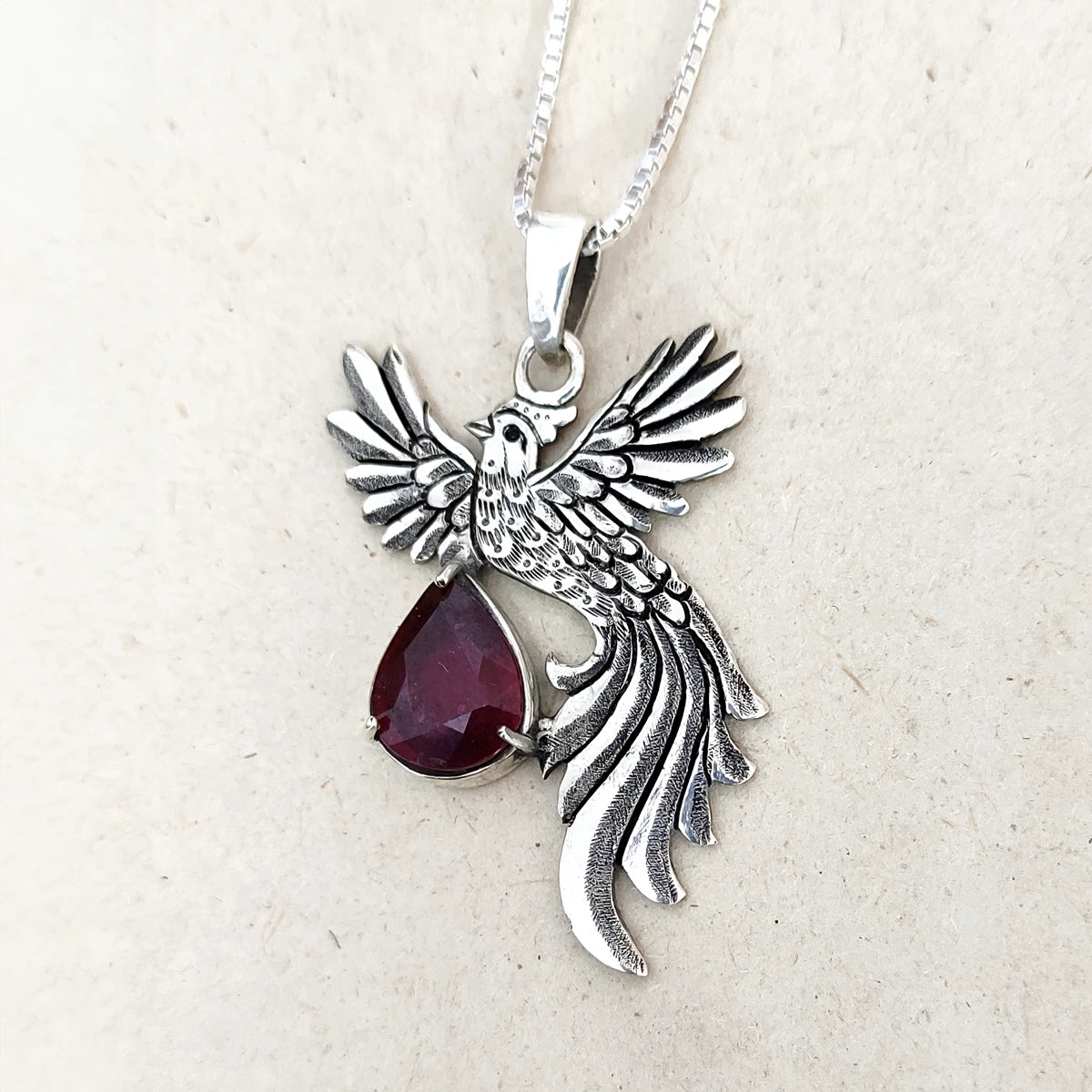 hand-engraved silver phoenix pendant with ruby