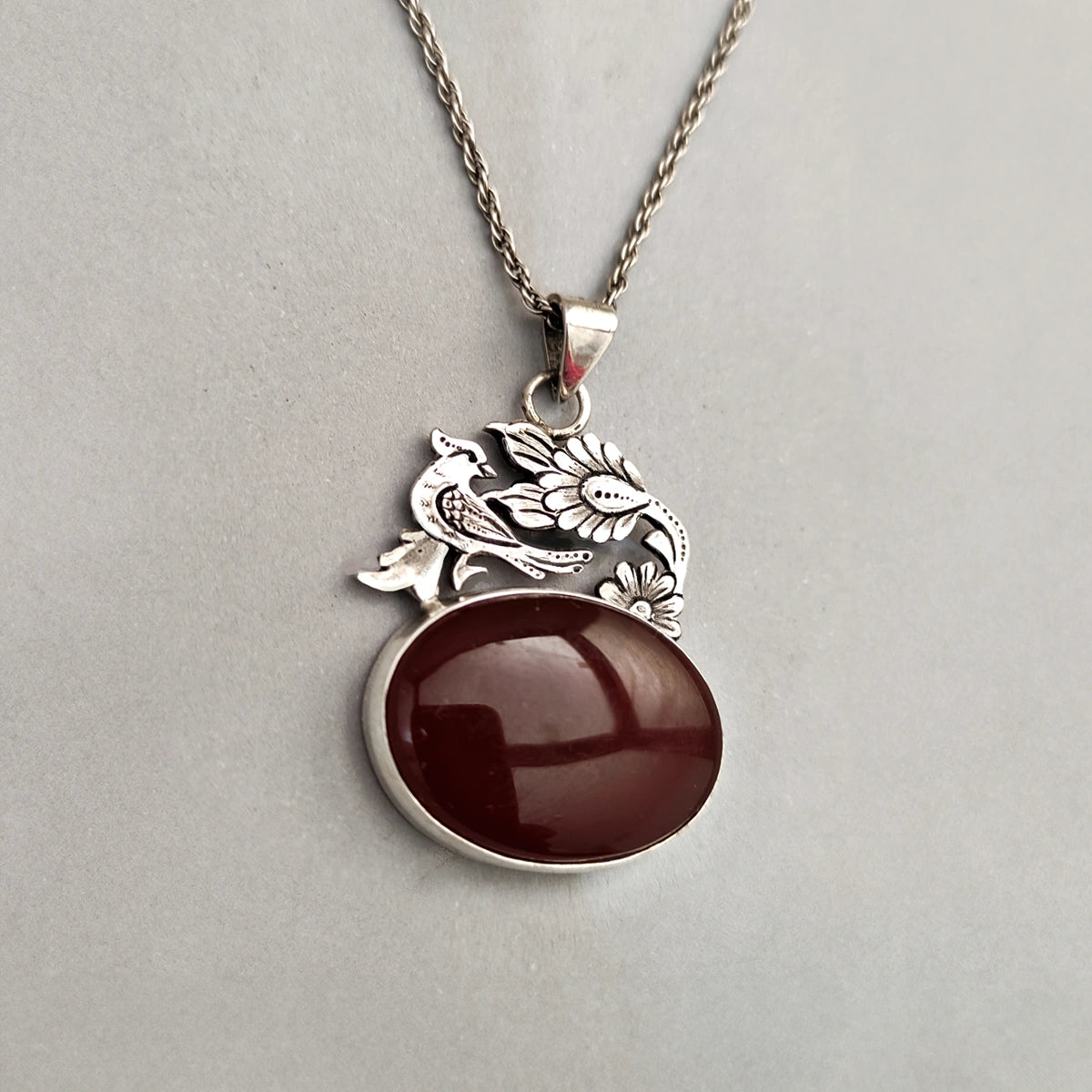 hand-engraved delicate bird and flower silver pendant with red agate