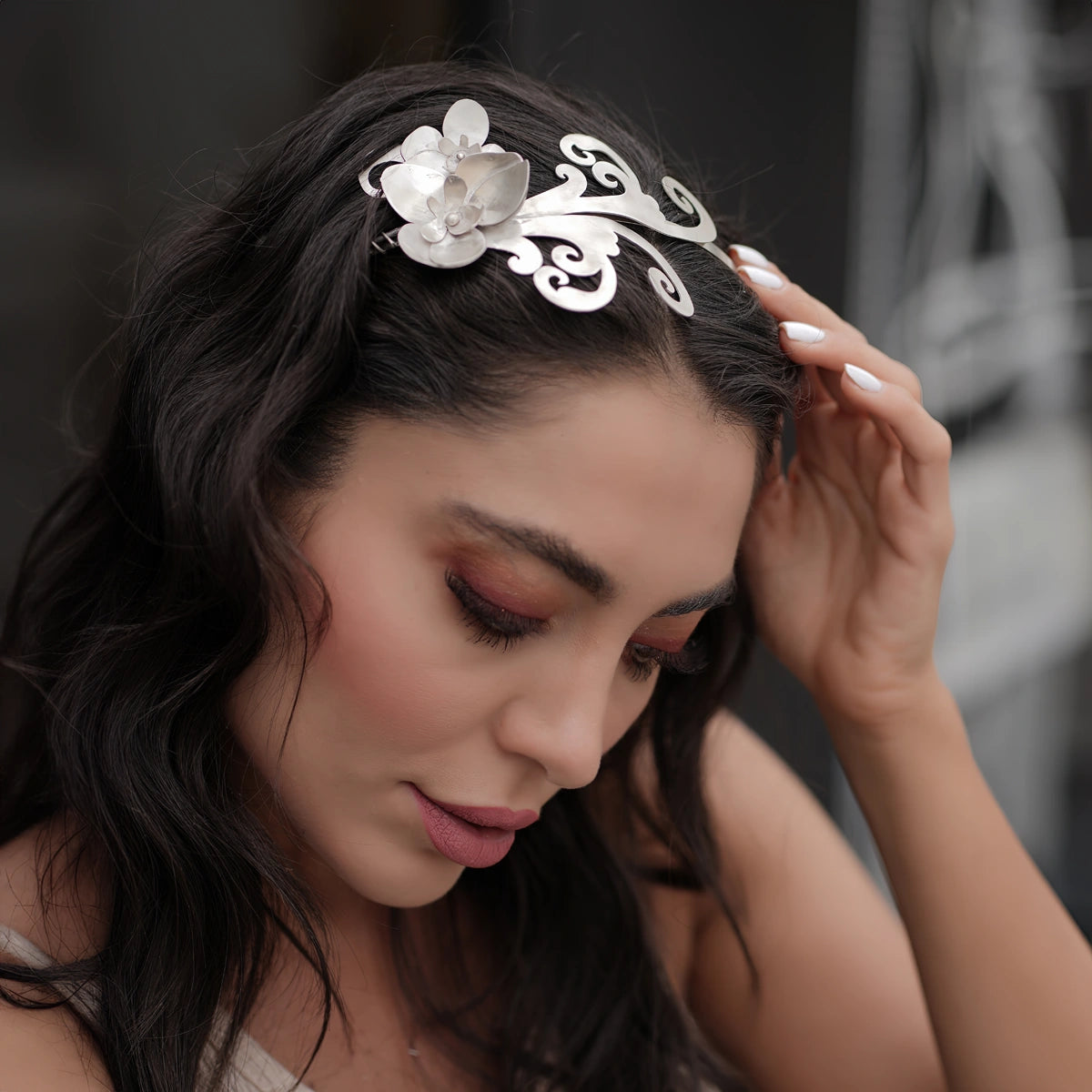 model wearing handmade silver headpiece decorated with silver orchids