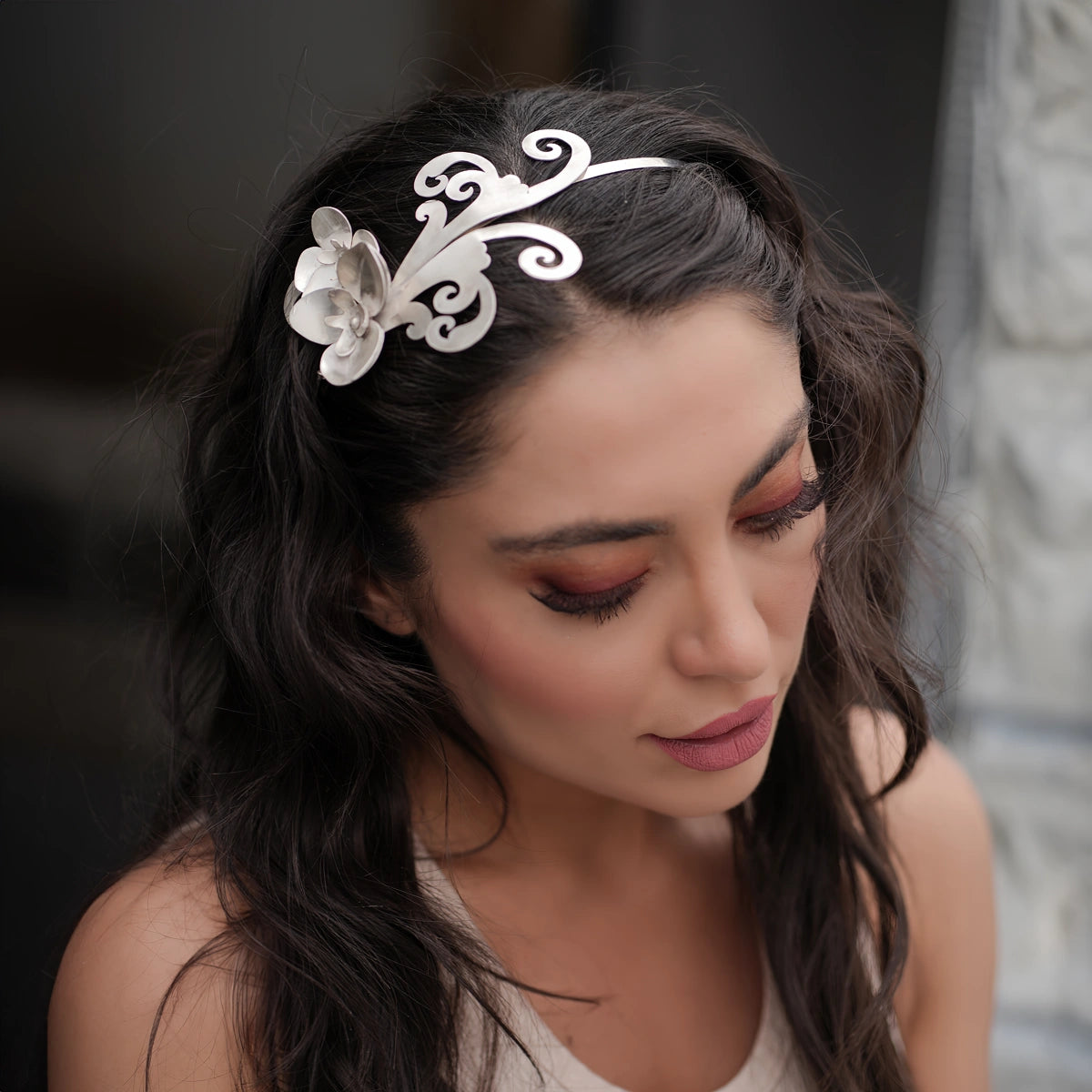 model wearing handmade silver headpiece decorated with silver orchids