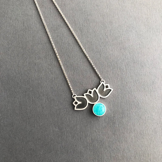 handmade oxidized silver necklace adorned with three flowers and a round amazonite