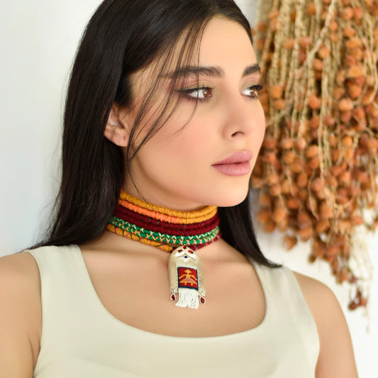 model wearing handmade silver necklace with Persian kilim inspired merino rug framed with silver decorations