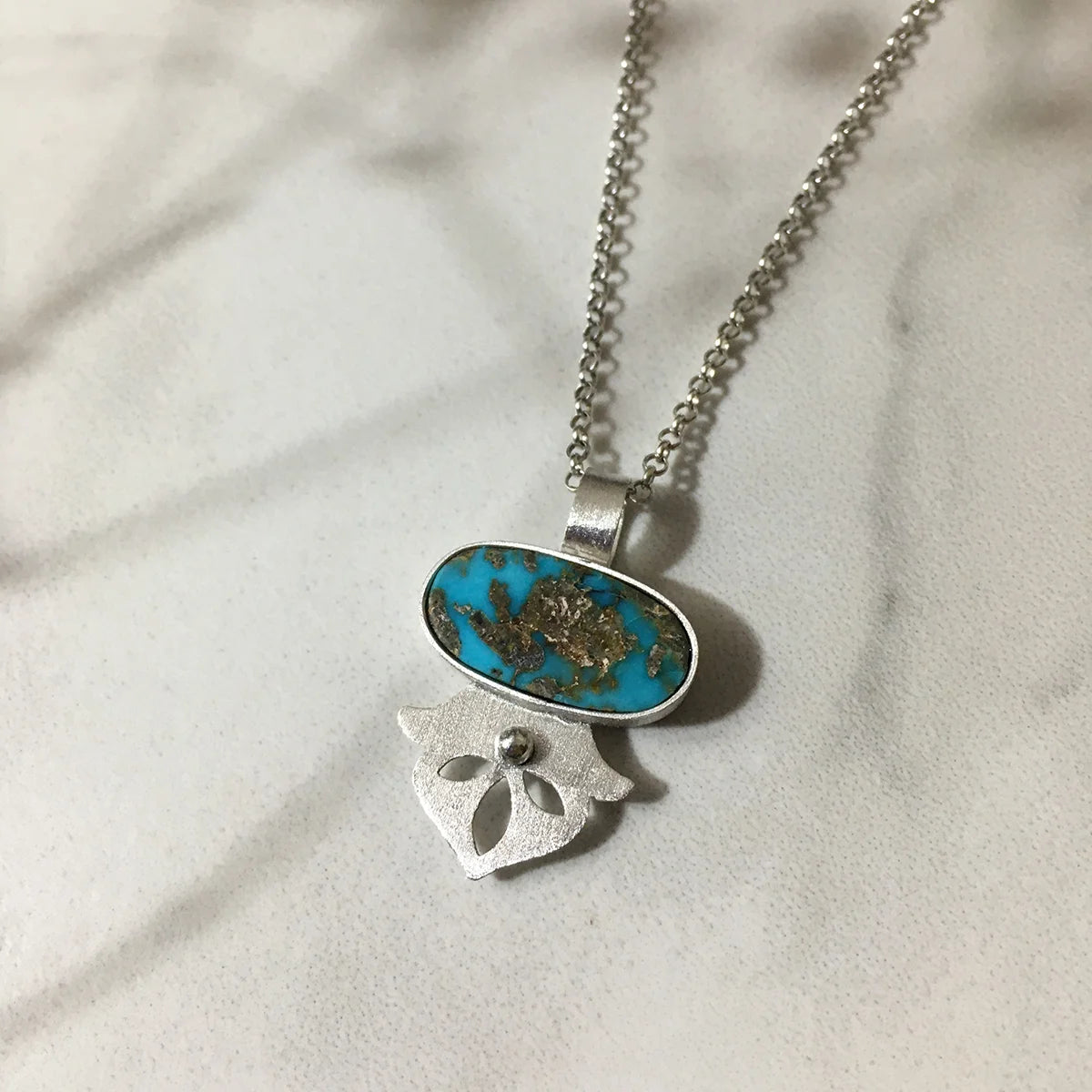 handmade silver statement pendant necklace decorated with turquoise and floral shape