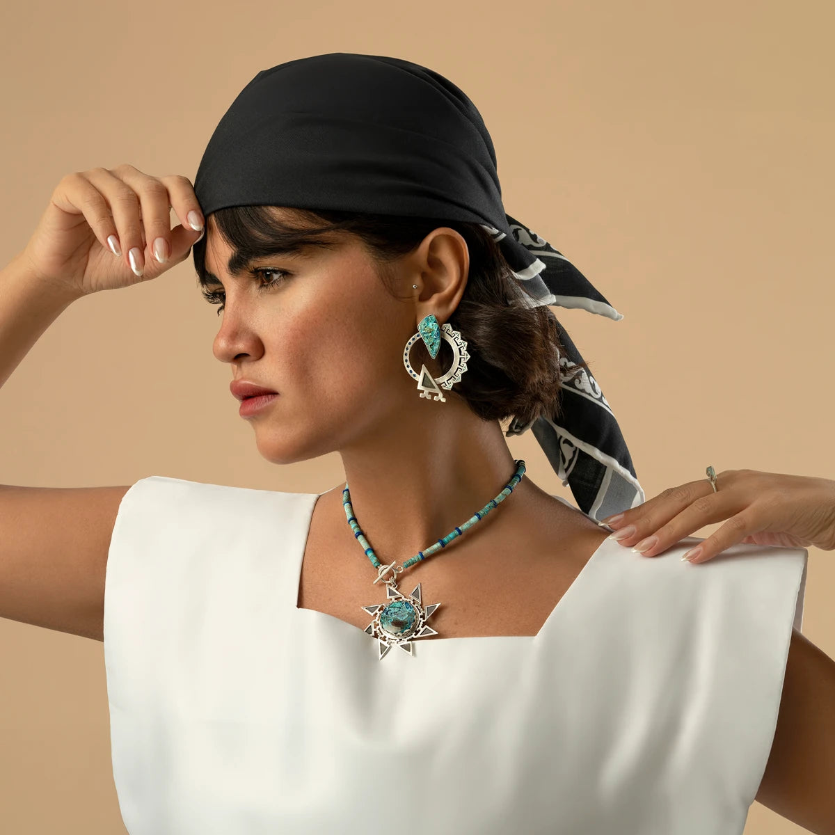model wearing handmade a set of earrings and star-shaped silver necklace with shuttukite, lapis lazuli and African Turquoise