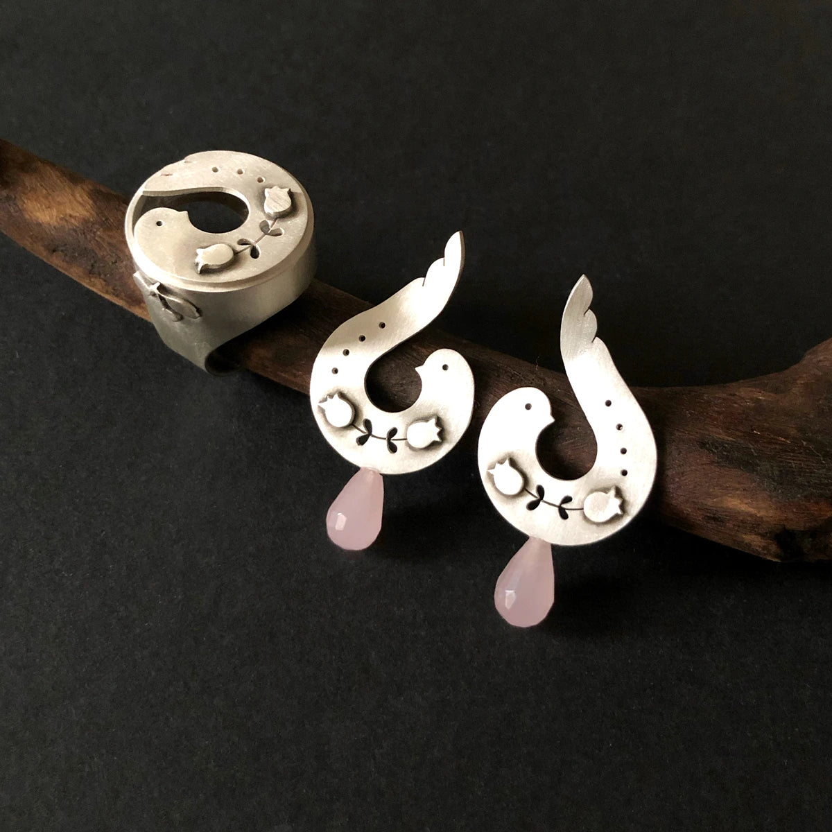 handmade silver statement bird ring and earrings with flower motifs