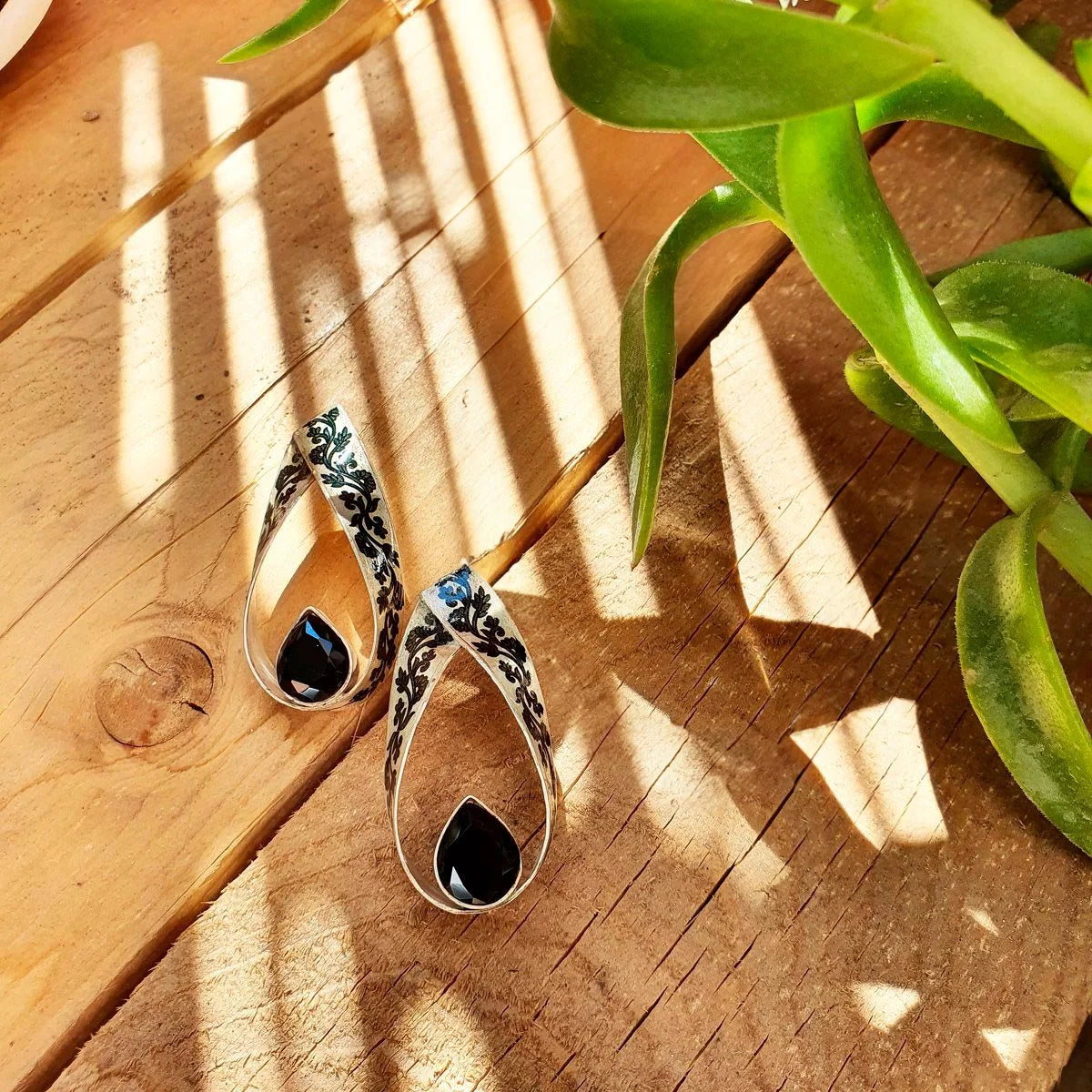 Handmade silver statement drop earrings decorated with hand-printed black floral patterns and tear-drop black cubic zirconia crystals