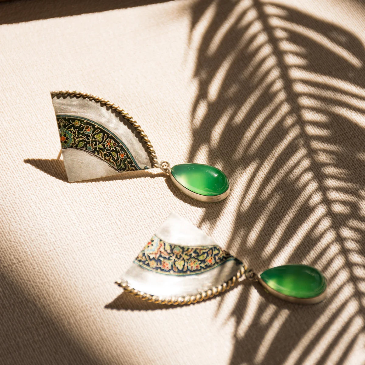 Handmade silver statement drop earrings decorated with floral patterns and green agate.