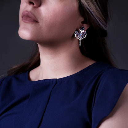 model wearing handmade silver ear jacket and dangle earrings adorned with lapis lazuli and floral patterns