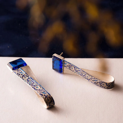 handmade silver drop earrings with blue spinel and intricate blue floral patterns