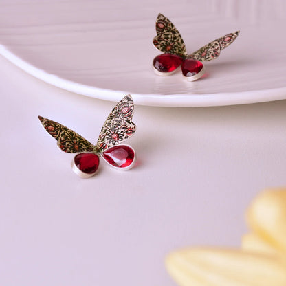 handmade silver butterfly stud earrings with floral patterns and red cubic zirconia