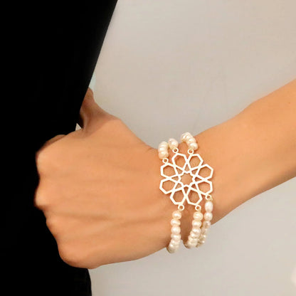 model wearing geometric star emblem handmade silver pearl bracelet