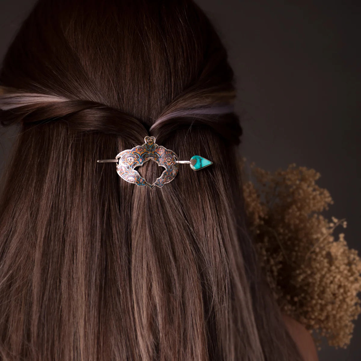 woman wearing handmade hairpin barrette with multicolored floral patterns and turquoise