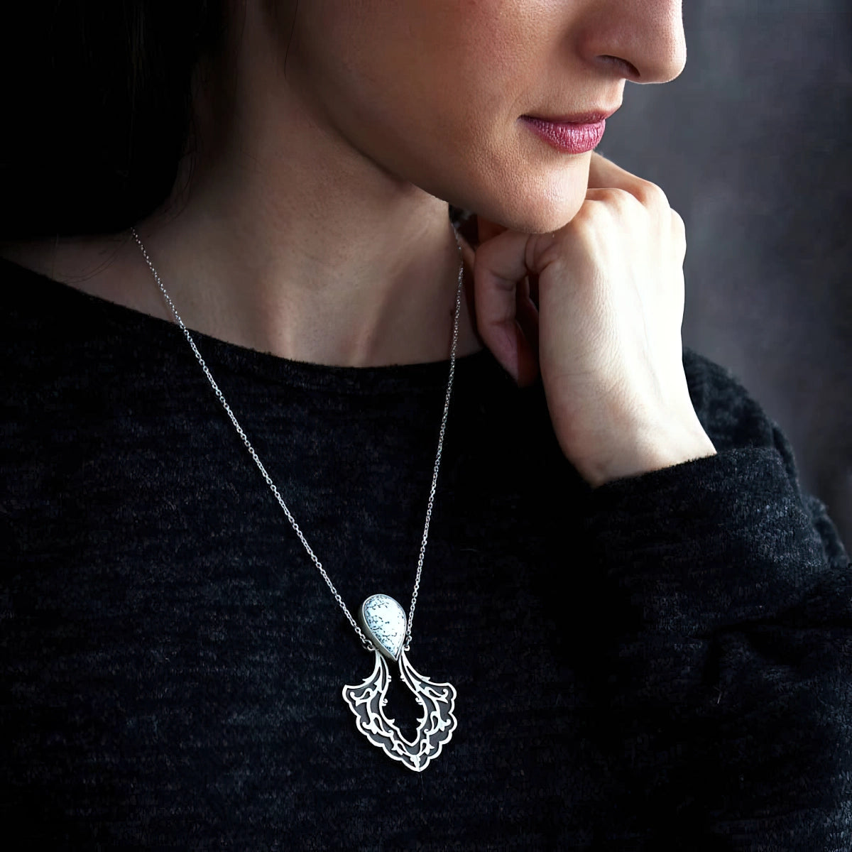 model wearing handmade oxidized silver pendant necklace with white dendritic agate