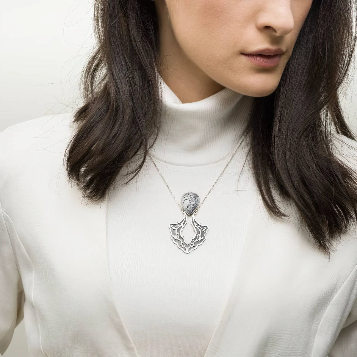 model wearing handmade oxidized silver pendant necklace with white dendritic agate