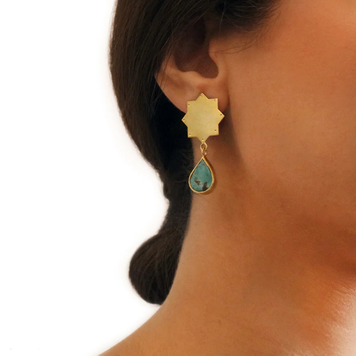 model wearing handmade gold plated silver star earrings with teardrop turquoise