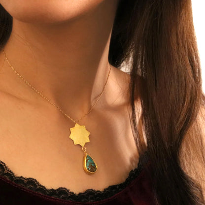 model wearing star shaped handmade gold plated silver pendant necklace with tear drop turquoise