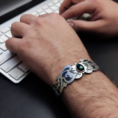 male model wearring handmade oxidized silver cuff bracelet with malachite