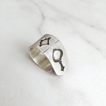 handmade oxidized silver statement ring with musical instrument shapes indented 