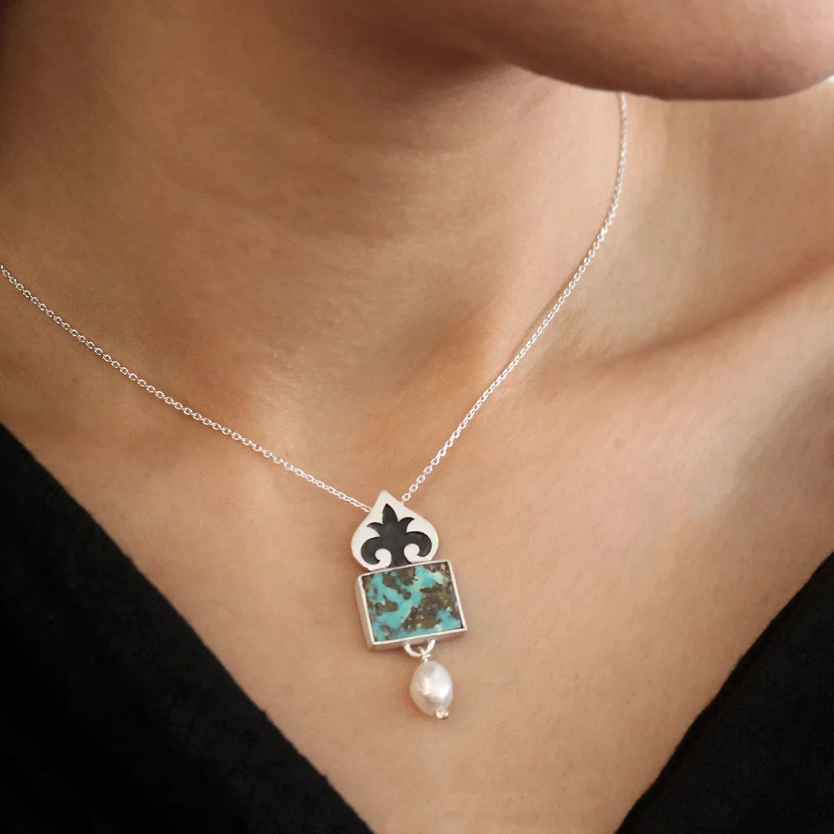 model wearing pomegranate flower handmade silver pendant necklace with turquoise and pearl