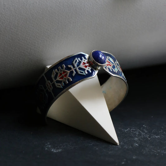handmade silver and enamel statement bracelet with geometric pattern, red accents and oval lapis lazuli