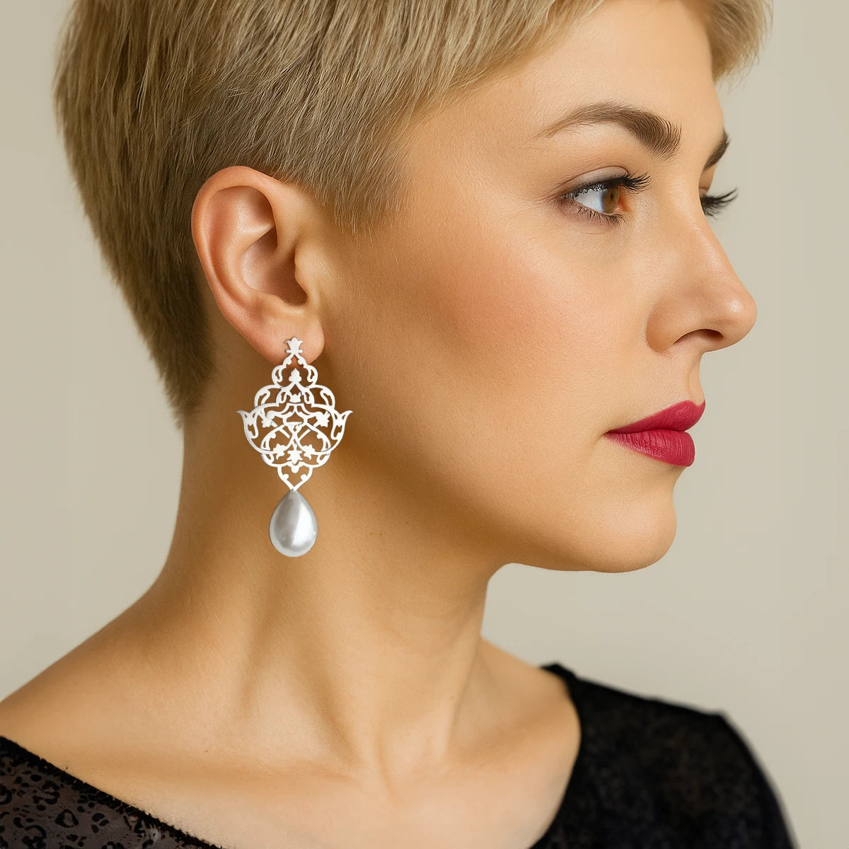 model wearing handmade silver lattice earrings with faux pearl teardrops and openwork floral arabesque design