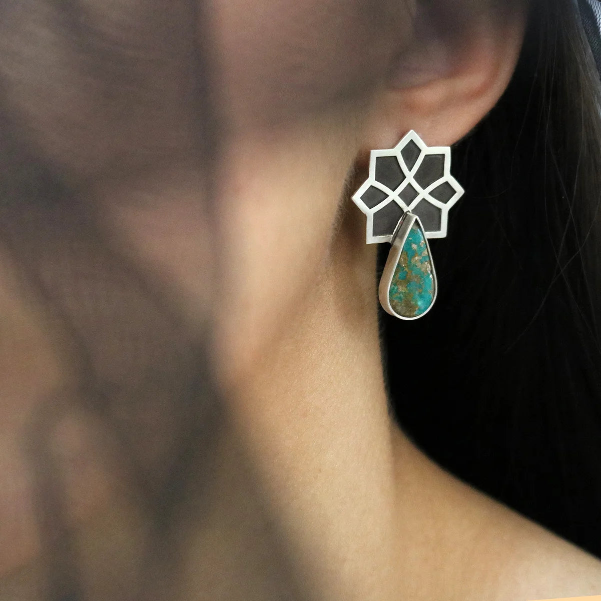 model wearing handmade silver stud earrings with tear drop turquoise