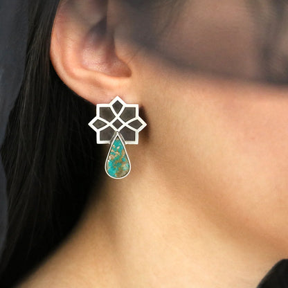 model wearing handmade silver stud earrings with tear drop turquoise