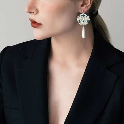 model wearing handmade silver and enamel drop earrings with elongated teardrop shells