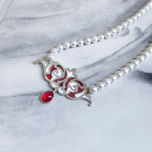 handmade silver and enamel necklace with shell bead chain and red spinel