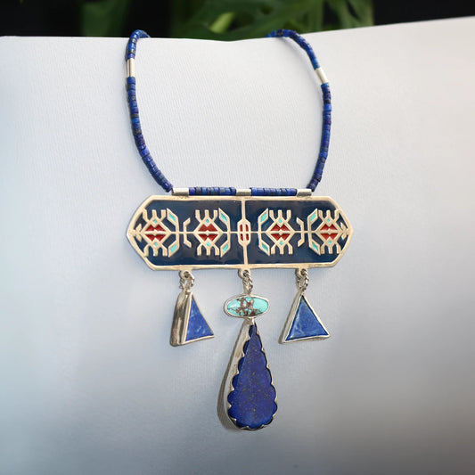 handmade statement silver necklace with geometric patterns and decorated with blue enamel and red accents, lapis lazuli and turquoise.
