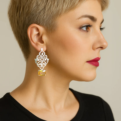 model wearing Handmade silver openwork earrings with intricate Persian-inspired floral motifs and yellow crystals.