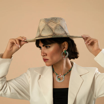 model wearing handmade ornate silver circle statement earrings and necklace with malachite and red cold enamel details