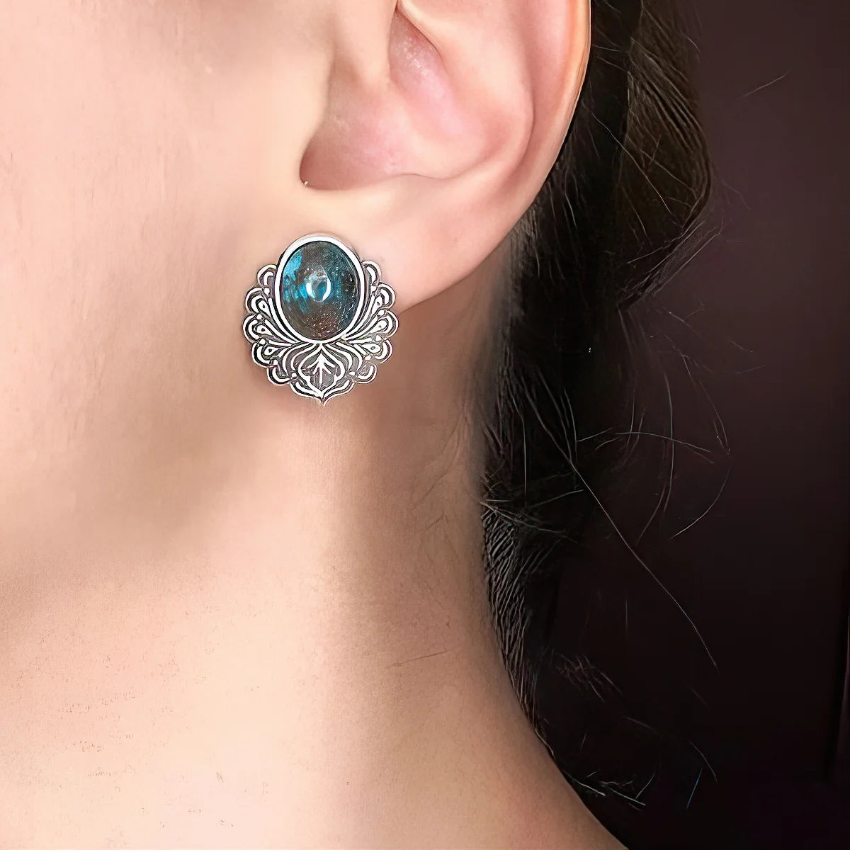 model wearing minimalistic oxidized silver stud earrings adorned with turquoise